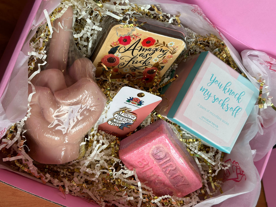 Final image of the dirty bitch gift box including crinkle packaging in a pink box