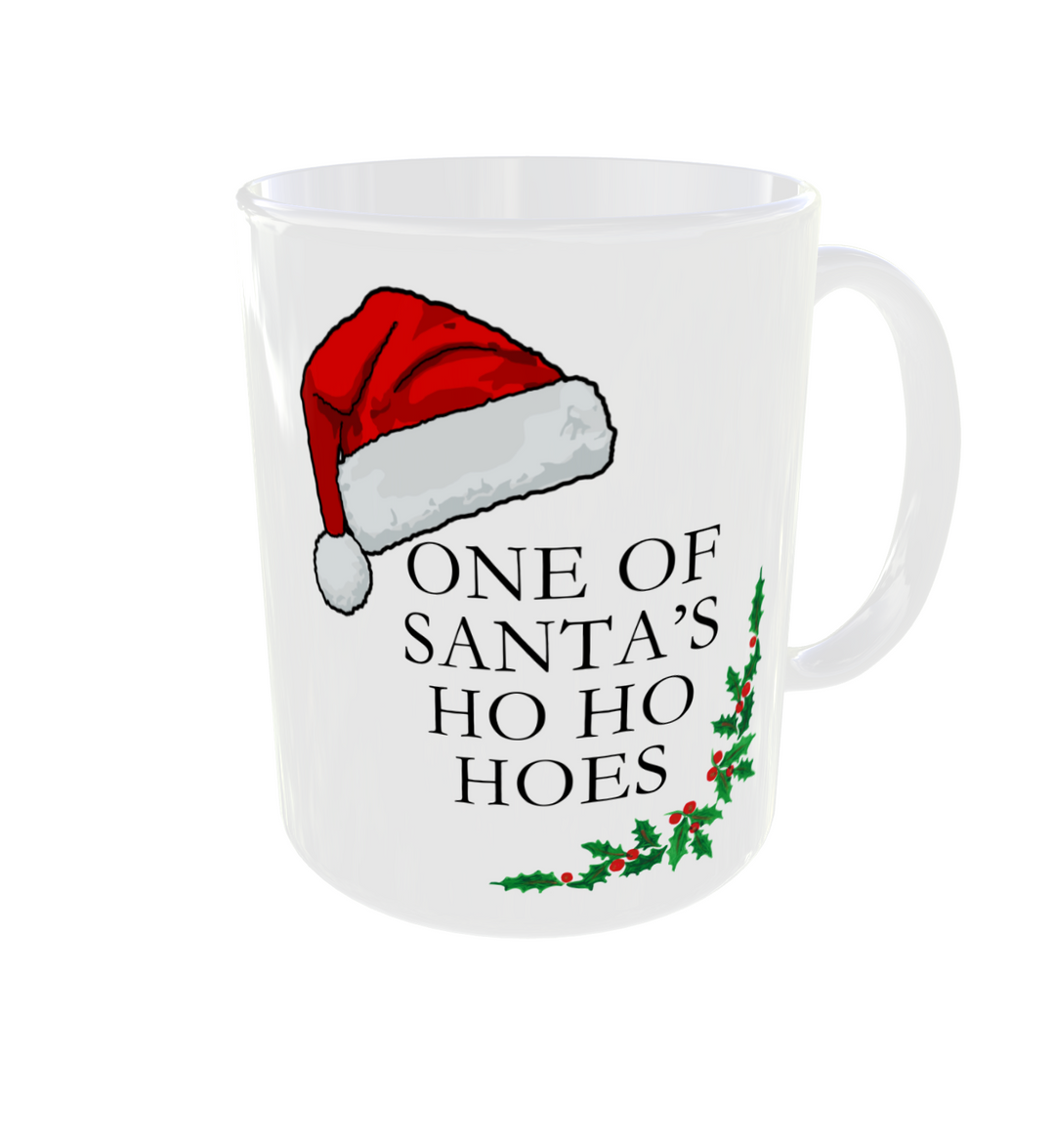 Christmas mug. One of Santa's Ho Ho Hoes is the message with a santa hat and holly on a white mug.
